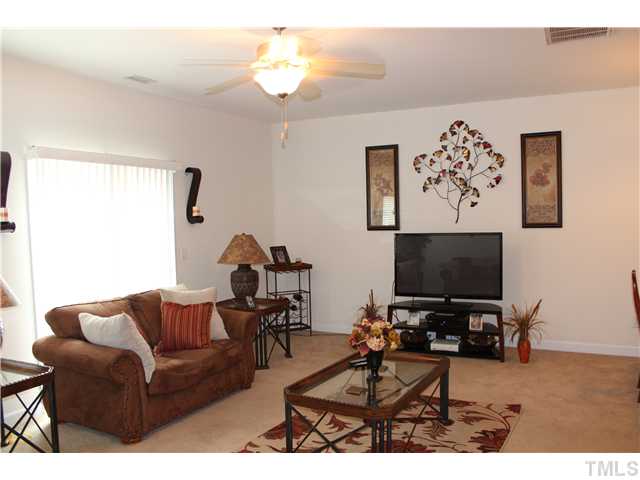 2545 Spring Oaks Way Raleigh, NC 27614 - Photo 6 of 12 Spacious living room with dining area and open to kitchen, ceiling fan, great natural light