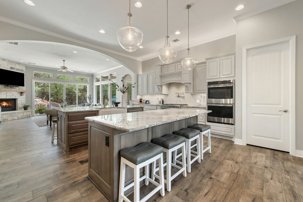 108 Berry Cove Georgetown, TX 78628 - Photo 11 of 39 a kitchen with stainless steel appliances granite countertop a stove oven and a refrigerator