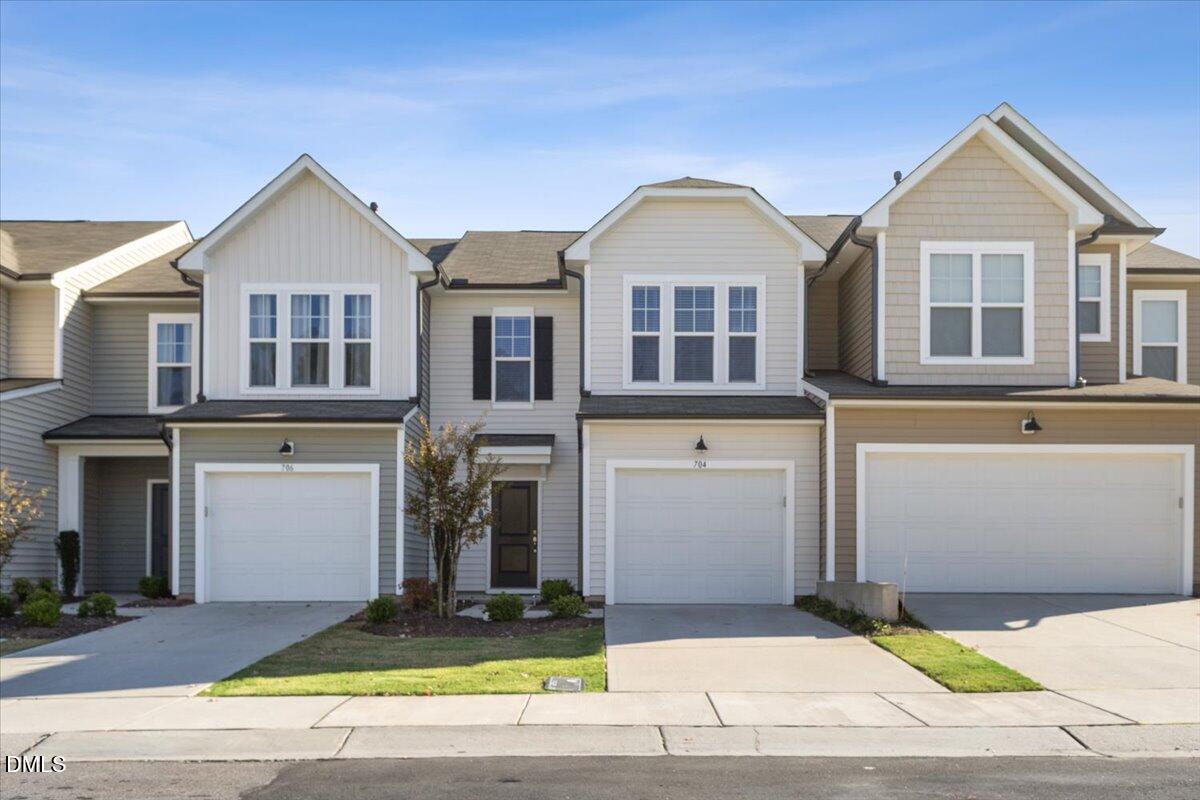 704 Colby Place Durham, NC 27713 - Photo 1 of 34 a front view of a house with a yard and garage