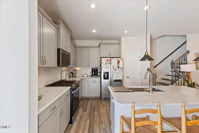 a kitchen with cabinets a sink and appliances