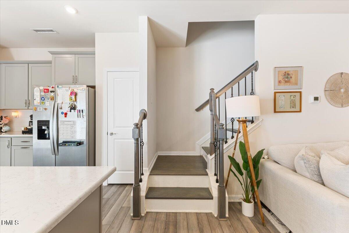 704 Colby Place Durham, NC 27713 - Photo 15 of 34 a living room with furniture a flat screen tv and a table
