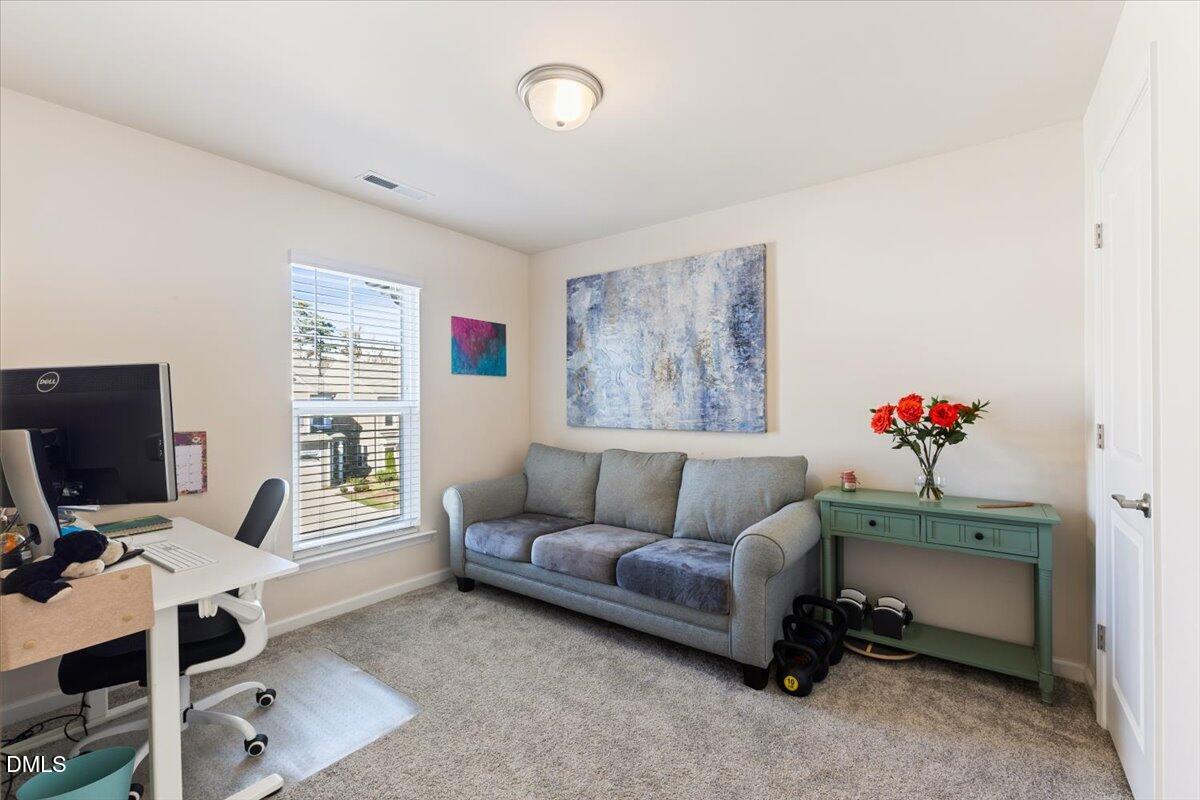 704 Colby Place Durham, NC 27713 - Photo 19 of 34 a living room with furniture and a flat screen tv