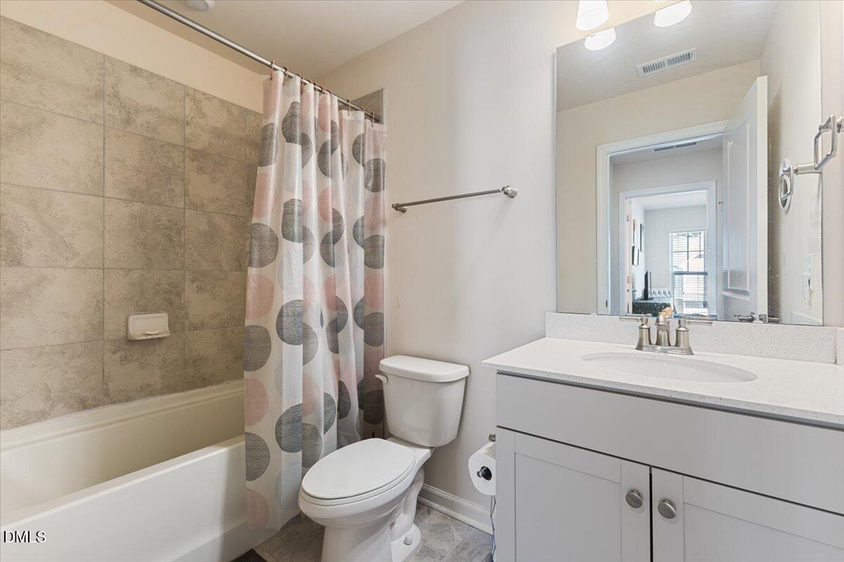 704 Colby Place Durham, NC 27713 - Photo 21 of 34 a bathroom with a sink toilet and shower