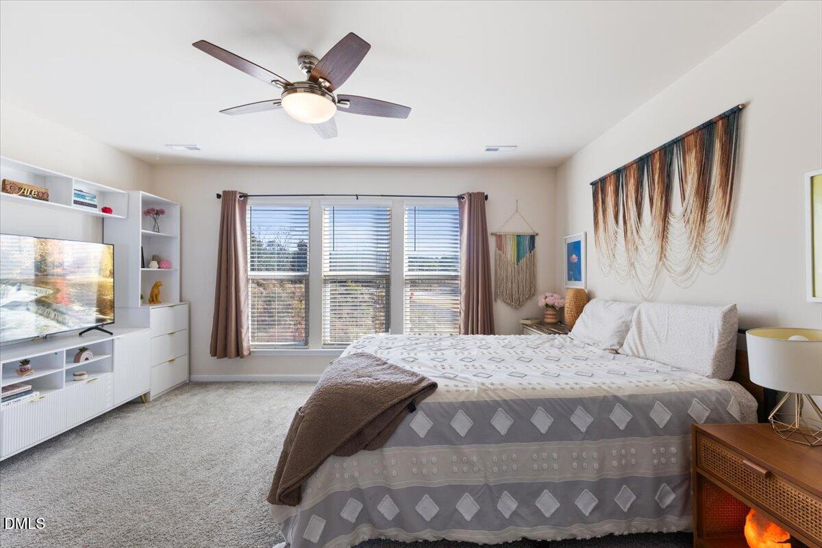 704 Colby Place Durham, NC 27713 - Photo 23 of 34 a bedroom with a bed window and flat screen tv