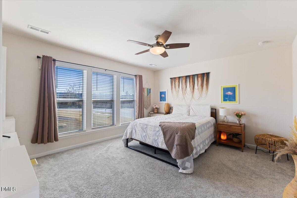 704 Colby Place Durham, NC 27713 - Photo 24 of 34 a spacious bedroom with a bed and a large window