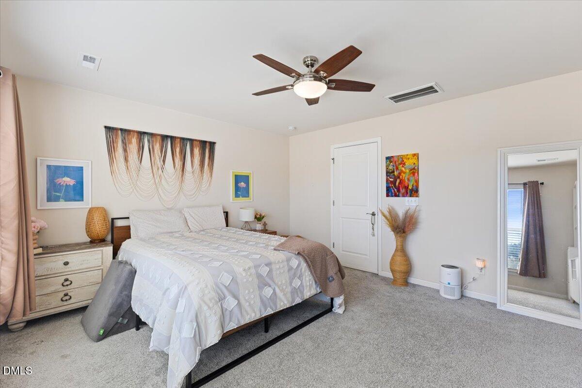 704 Colby Place Durham, NC 27713 - Photo 25 of 34 a bedroom with a bed and a chandelier