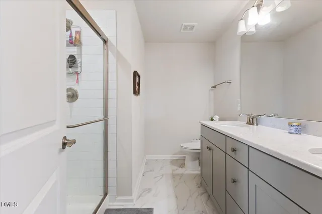 a bathroom with a double vanity sink and mirror