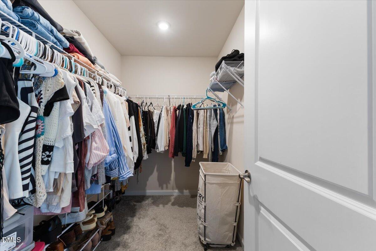 704 Colby Place Durham, NC 27713 - Photo 29 of 34 a view of walk in closet with clothes and shoes