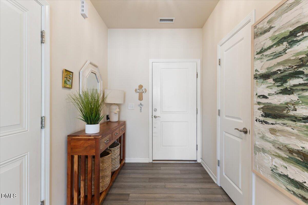 704 Colby Place Durham, NC 27713 - Photo 3 of 34 a view of a hallway with wooden floor and staircase