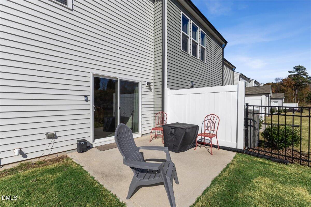 704 Colby Place Durham, NC 27713 - Photo 33 of 34 a view of backyard with seating space and wooden fence