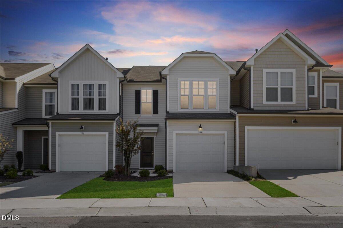 704 Colby Place Durham, NC 27713 - Photo 34 of 34 a front view of a house with a garden and a garage