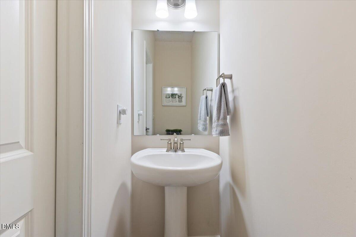 704 Colby Place Durham, NC 27713 - Photo 5 of 34 a bathroom with a sink and a mirror