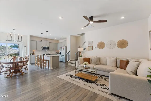 a living room with furniture and kitchen view