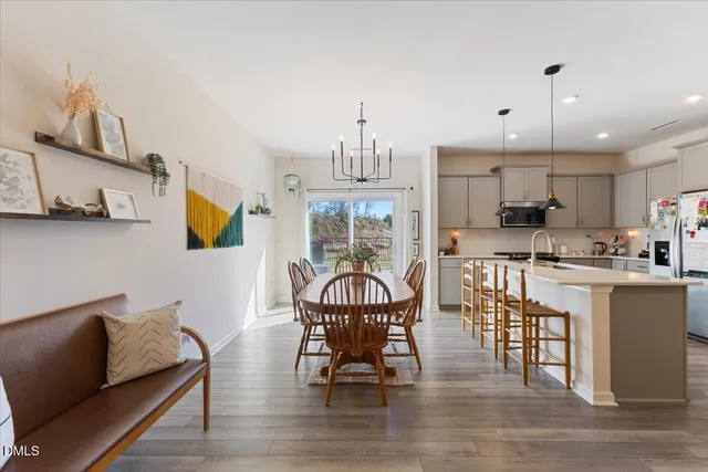 a living room with furniture a dining table and kitchen view