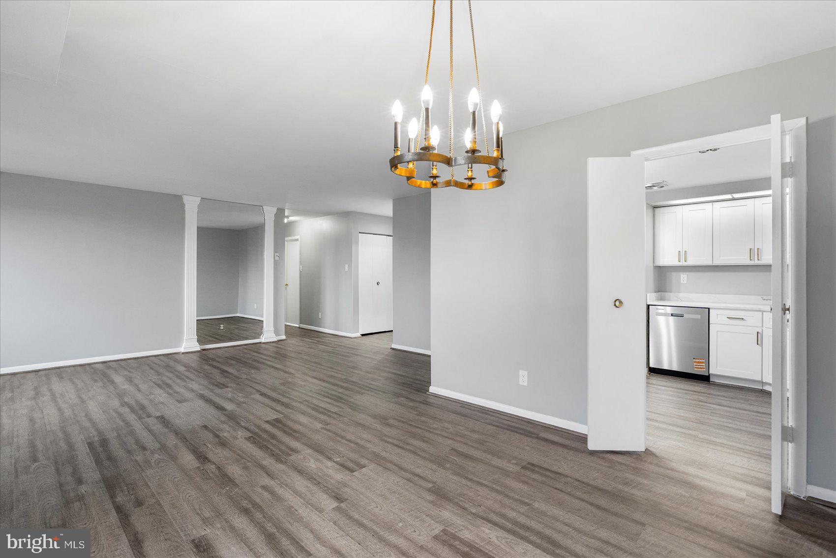 6317 Park Heights Avenue, Unit 616 Baltimore, MD 21215 - Photo 12 of 36 a view of a kitchen with wooden floor and window
