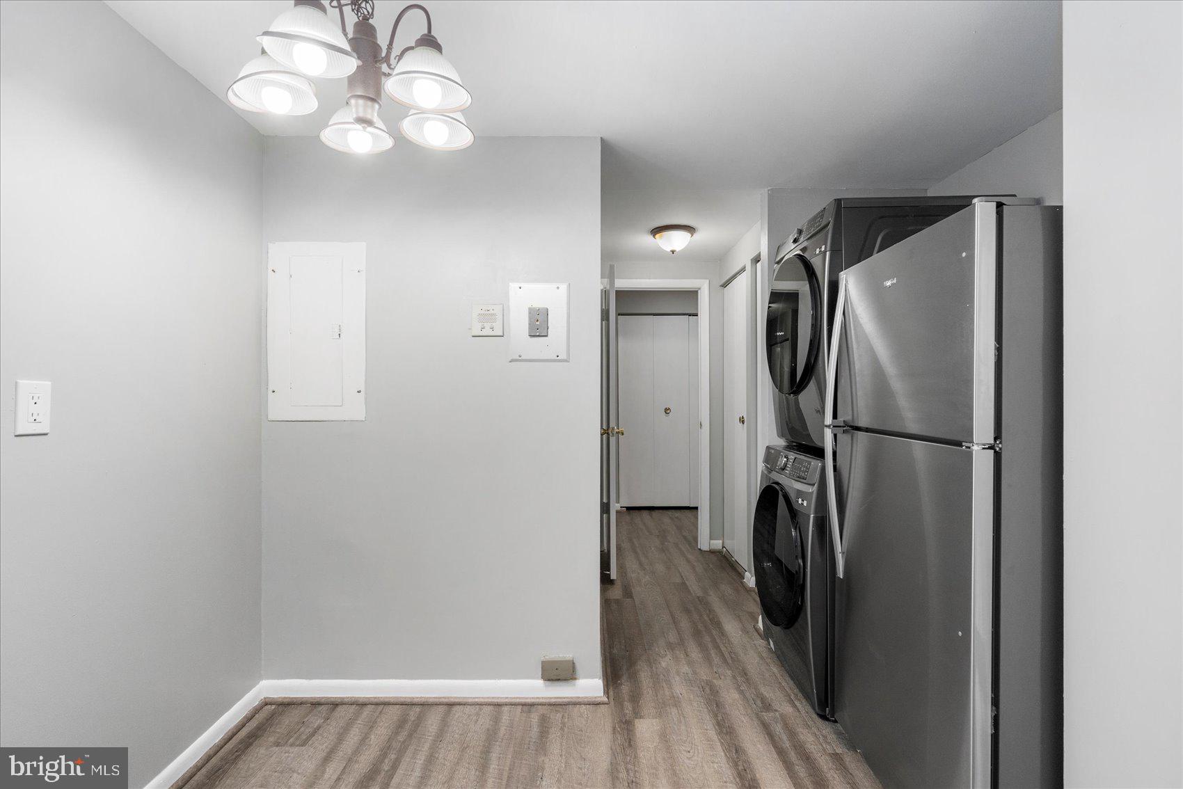 6317 Park Heights Avenue, Unit 616 Baltimore, MD 21215 - Photo 16 of 36 a view of a refrigerator in kitchen and a wooden floor