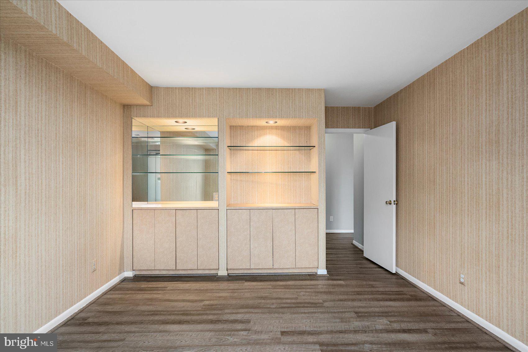 6317 Park Heights Avenue, Unit 616 Baltimore, MD 21215 - Photo 21 of 36 a view of an empty room with wooden floor and a window