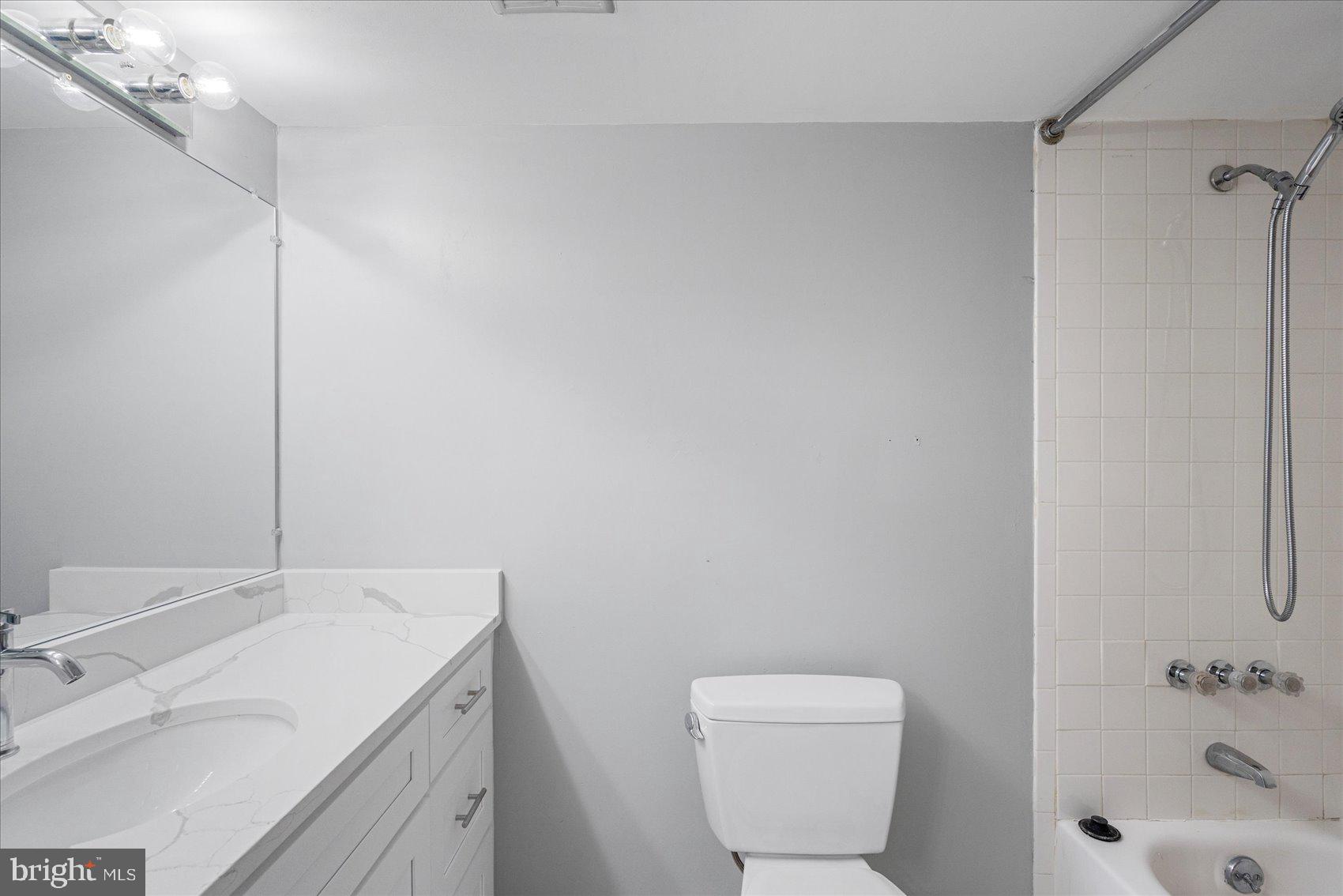 6317 Park Heights Avenue, Unit 616 Baltimore, MD 21215 - Photo 22 of 36 a bathroom with a sink a toilet and shower
