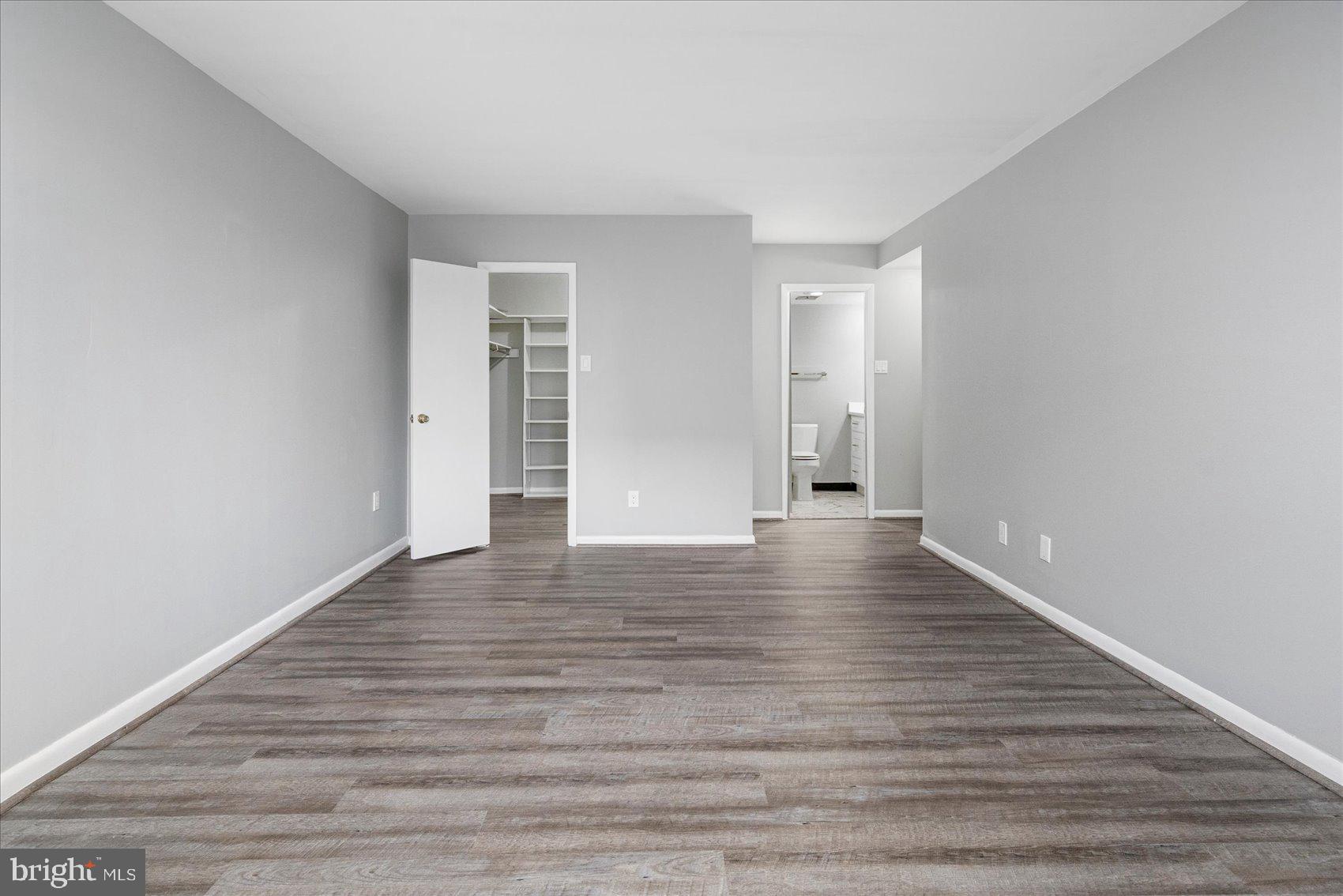 6317 Park Heights Avenue, Unit 616 Baltimore, MD 21215 - Photo 26 of 36 a view of an empty room with wooden floor and window