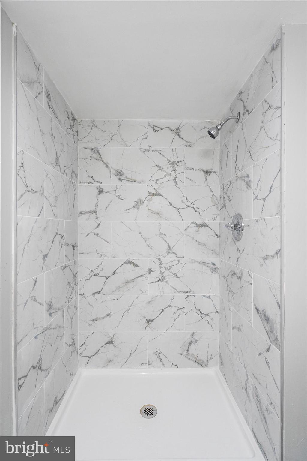 6317 Park Heights Avenue, Unit 616 Baltimore, MD 21215 - Photo 29 of 36 a bathroom with a bathtub and shower