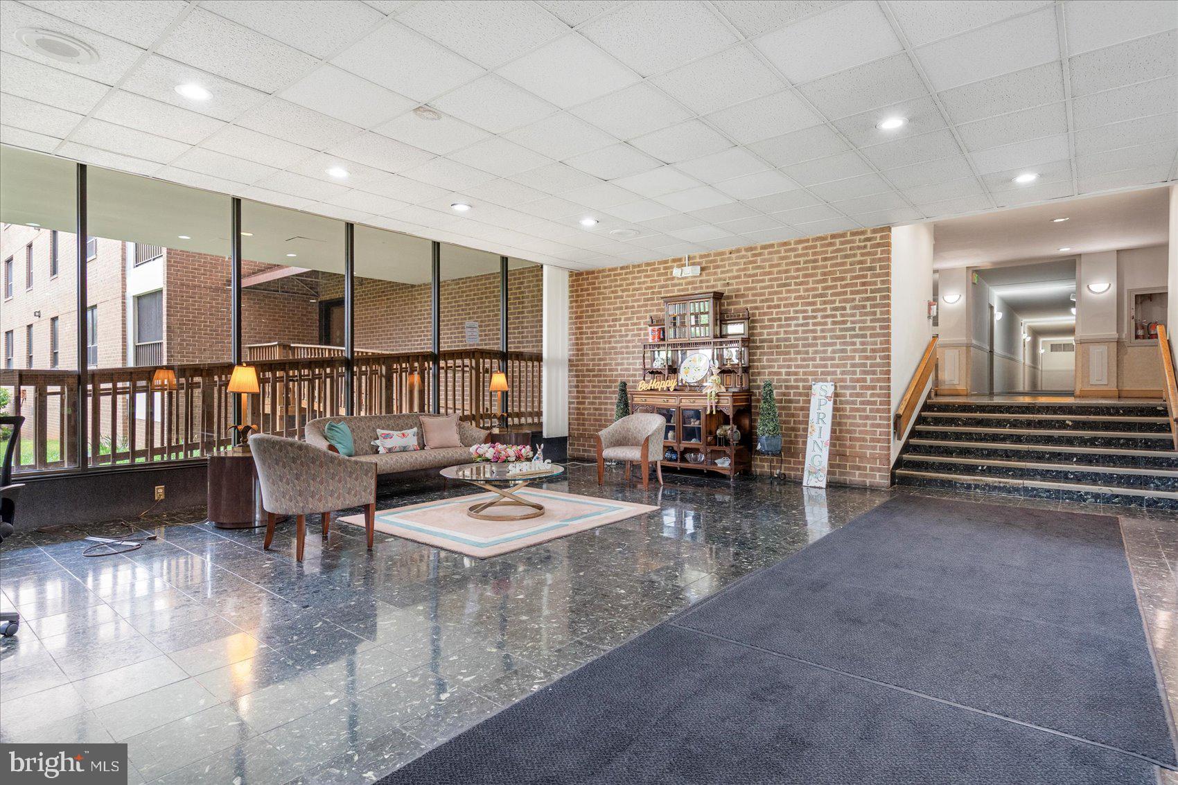6317 Park Heights Avenue, Unit 616 Baltimore, MD 21215 - Photo 3 of 36 a living room with furniture and a dining table with wooden floor