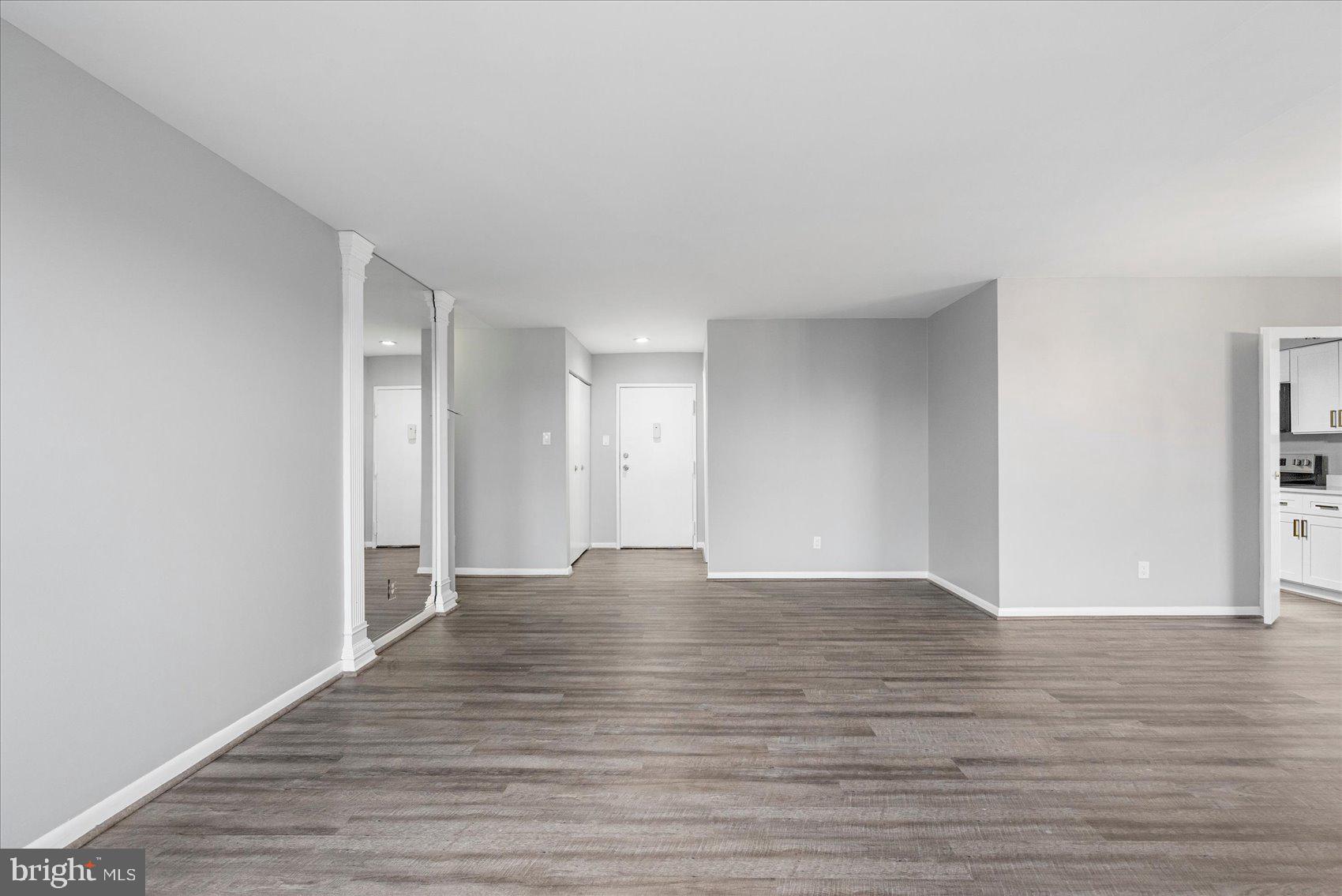 6317 Park Heights Avenue, Unit 616 Baltimore, MD 21215 - Photo 6 of 36 a view of an empty room and wooden floor