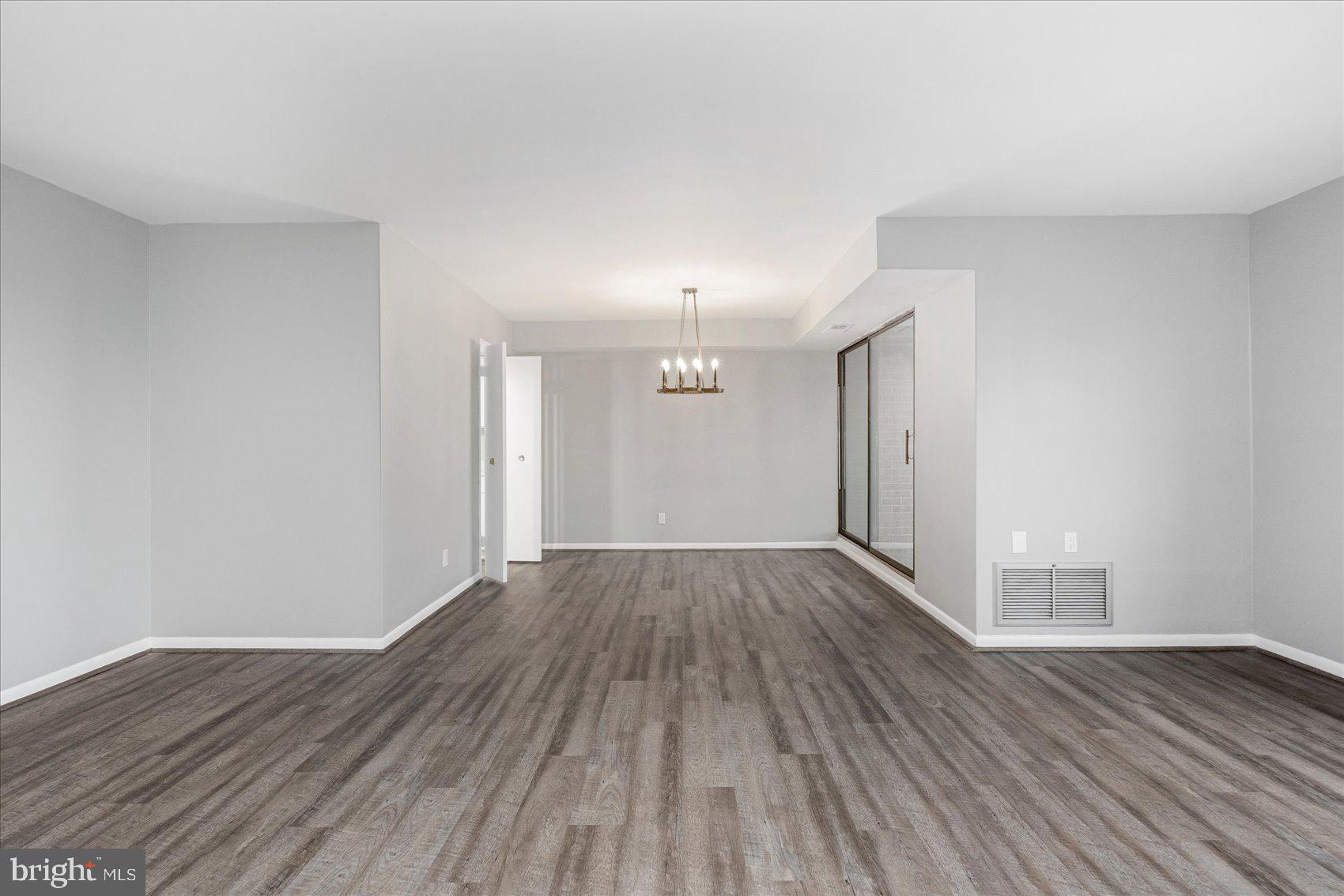 6317 Park Heights Avenue, Unit 616 Baltimore, MD 21215 - Photo 7 of 36 a view of wooden floor in an empty room