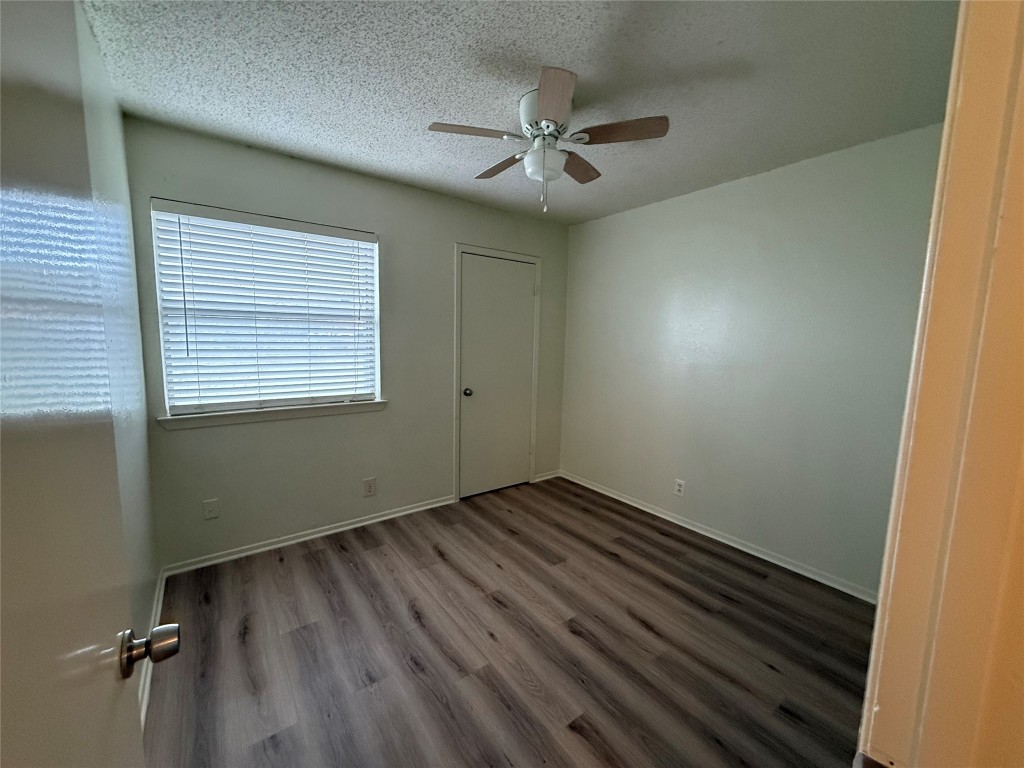 9810 Roxanna Drive, Unit C Austin, TX 78748 - Photo 8 of 10 a view of an empty room with wooden floor and a window