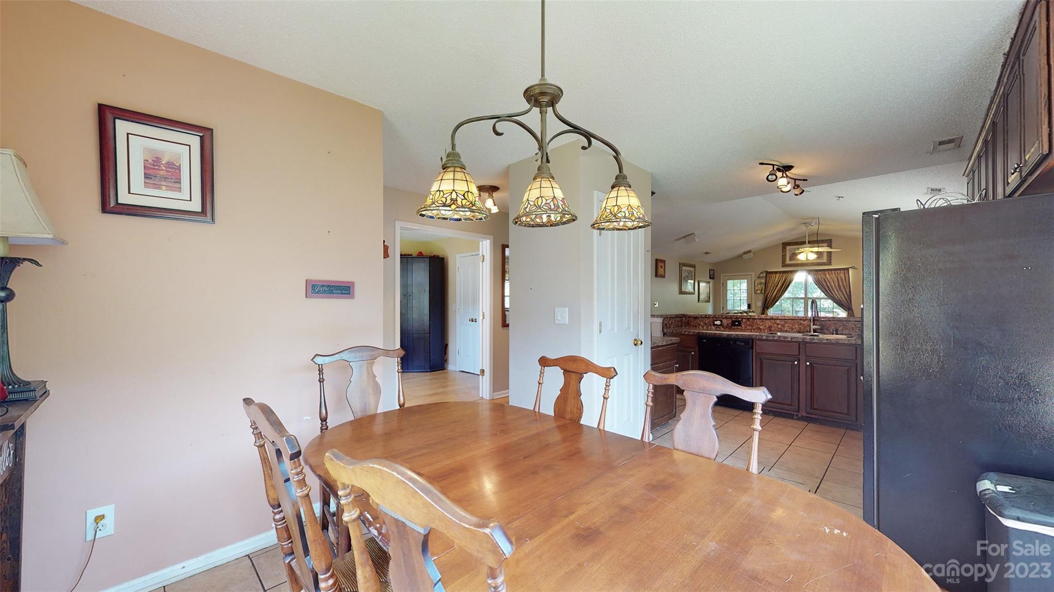 11506 Woodfire Road Charlotte, NC 28269 - Photo 13 of 48 a view of a dining room with furniture and a chandelier
