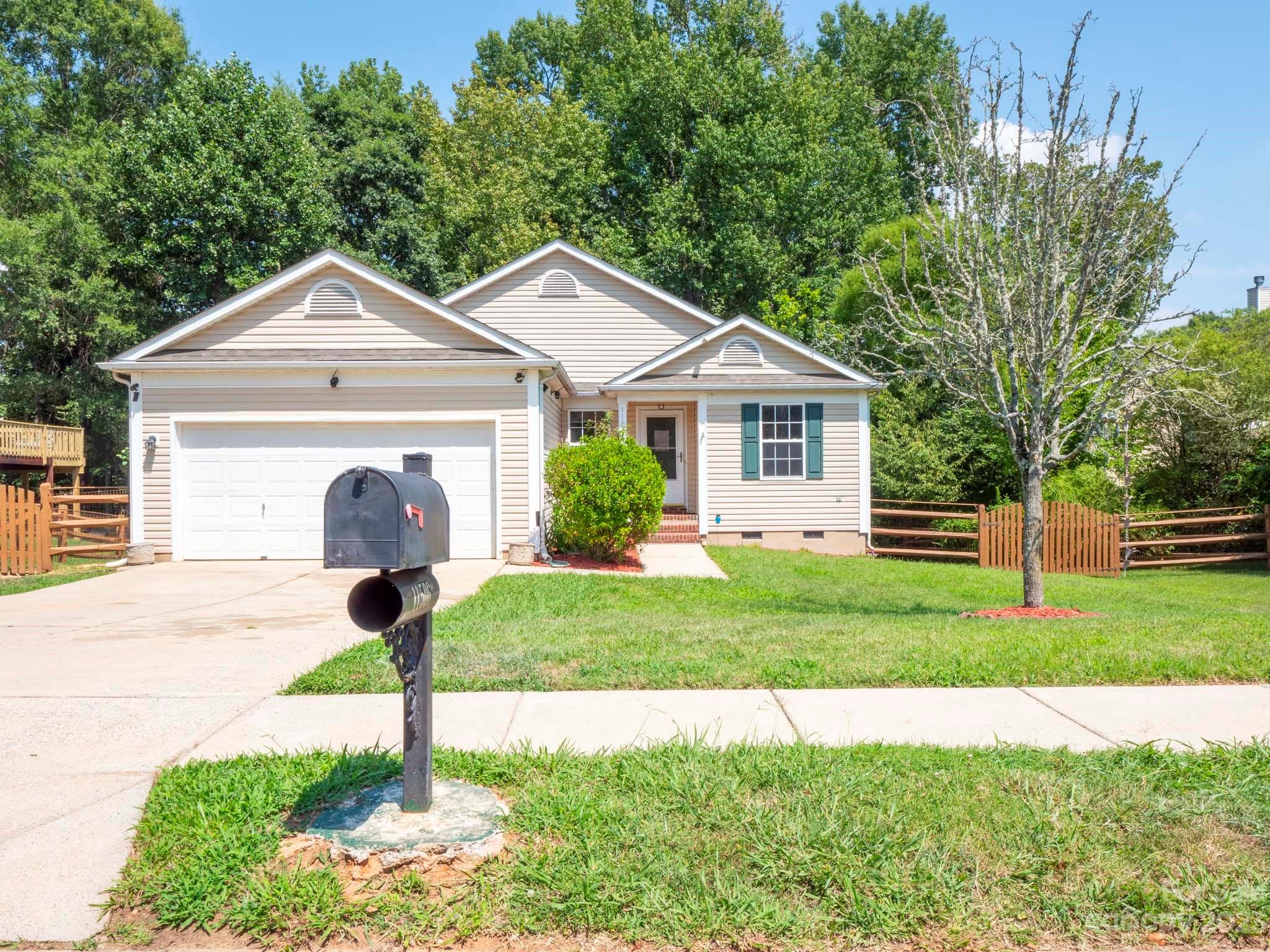 11506 Woodfire Road Charlotte, NC 28269 - Photo 2 of 48 a front view of a house with a yard and garage