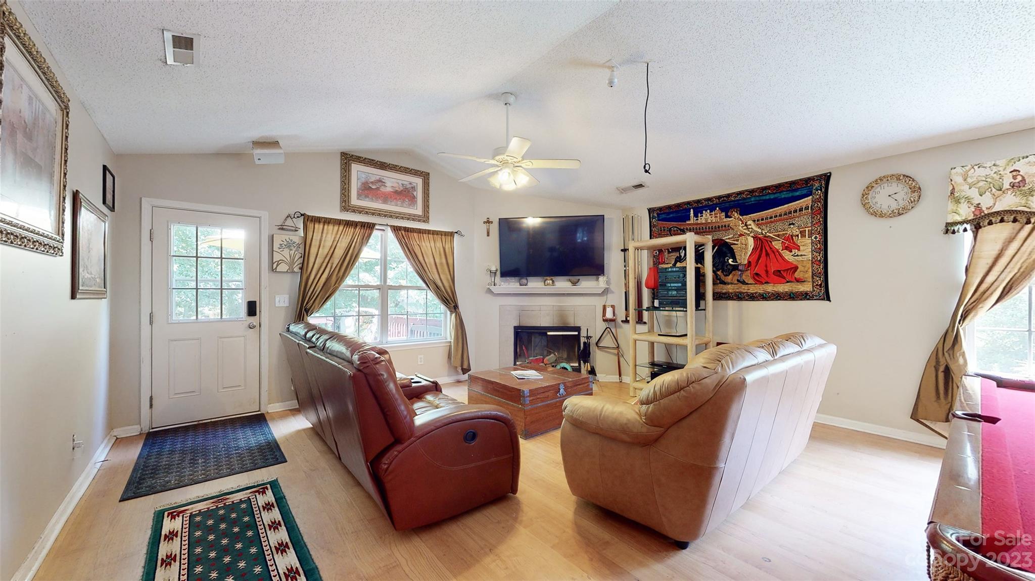 11506 Woodfire Road Charlotte, NC 28269 - Photo 24 of 48 a living room with furniture a flat screen tv and a fireplace