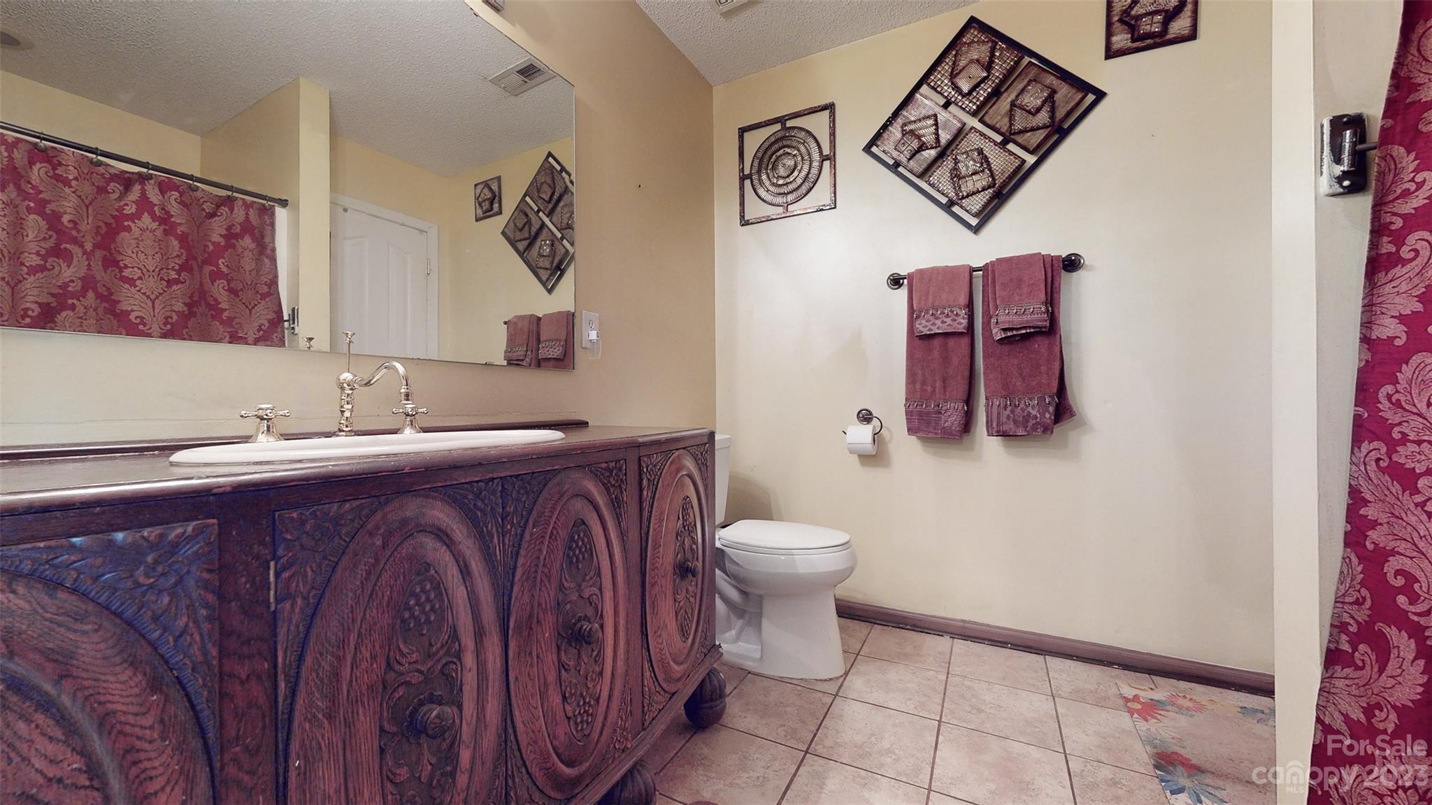 11506 Woodfire Road Charlotte, NC 28269 - Photo 34 of 48 a bathroom with a toilet sink and mirror