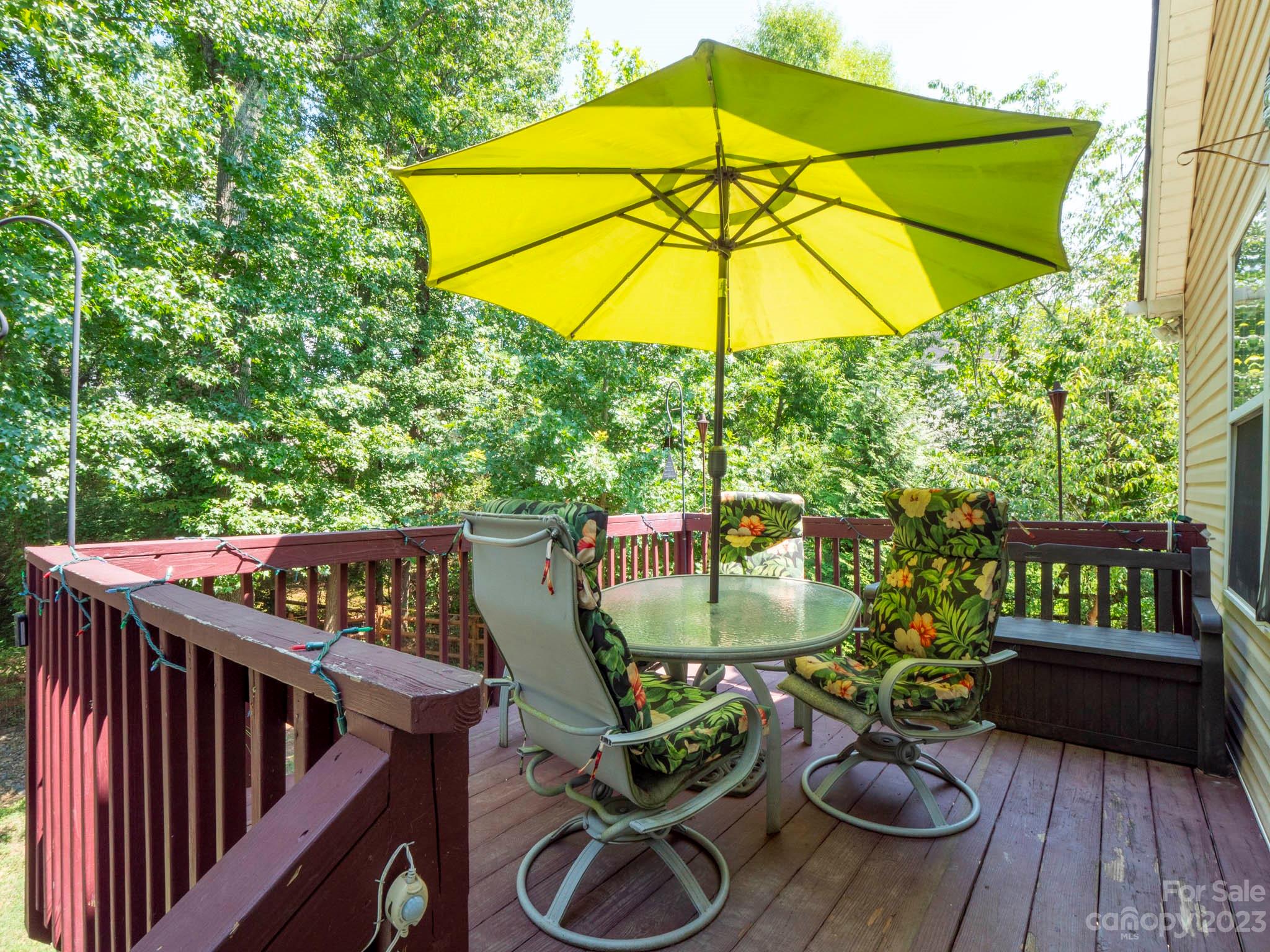 11506 Woodfire Road Charlotte, NC 28269 - Photo 45 of 48 an outdoor sitting area with furniture and umbrella