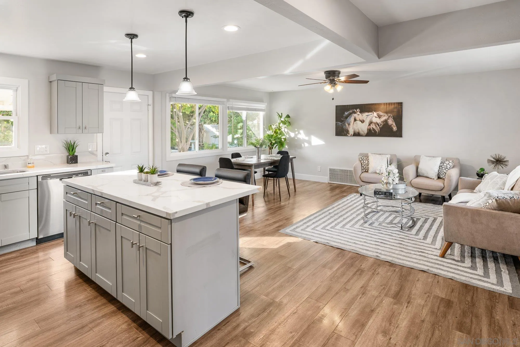 222 Gull Place El Cajon, CA 92019 - Photo 16 of 53 a kitchen with a sink stove and wooden cabinets