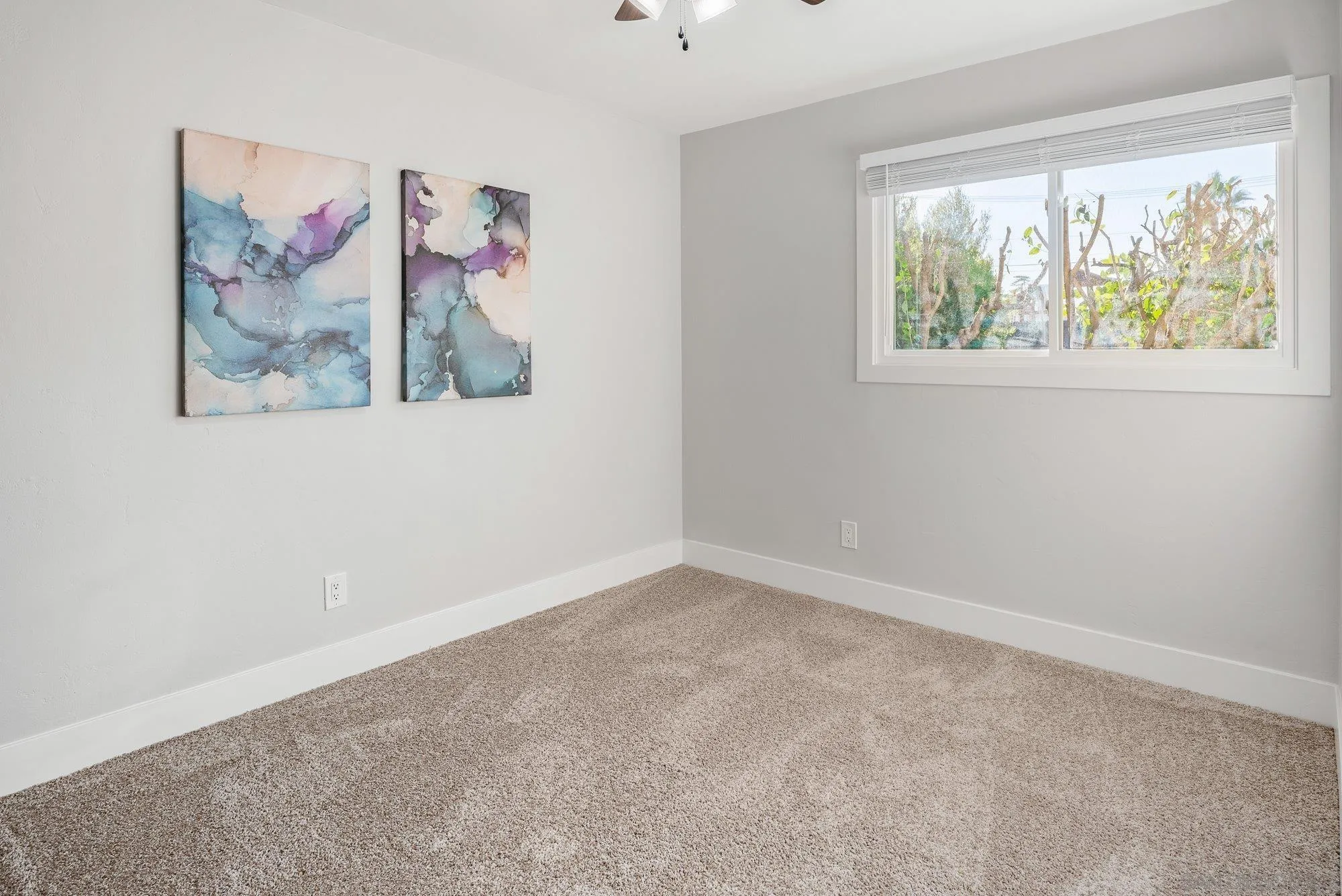 222 Gull Place El Cajon, CA 92019 - Photo 24 of 53 an empty room with a painting on the wall and a window