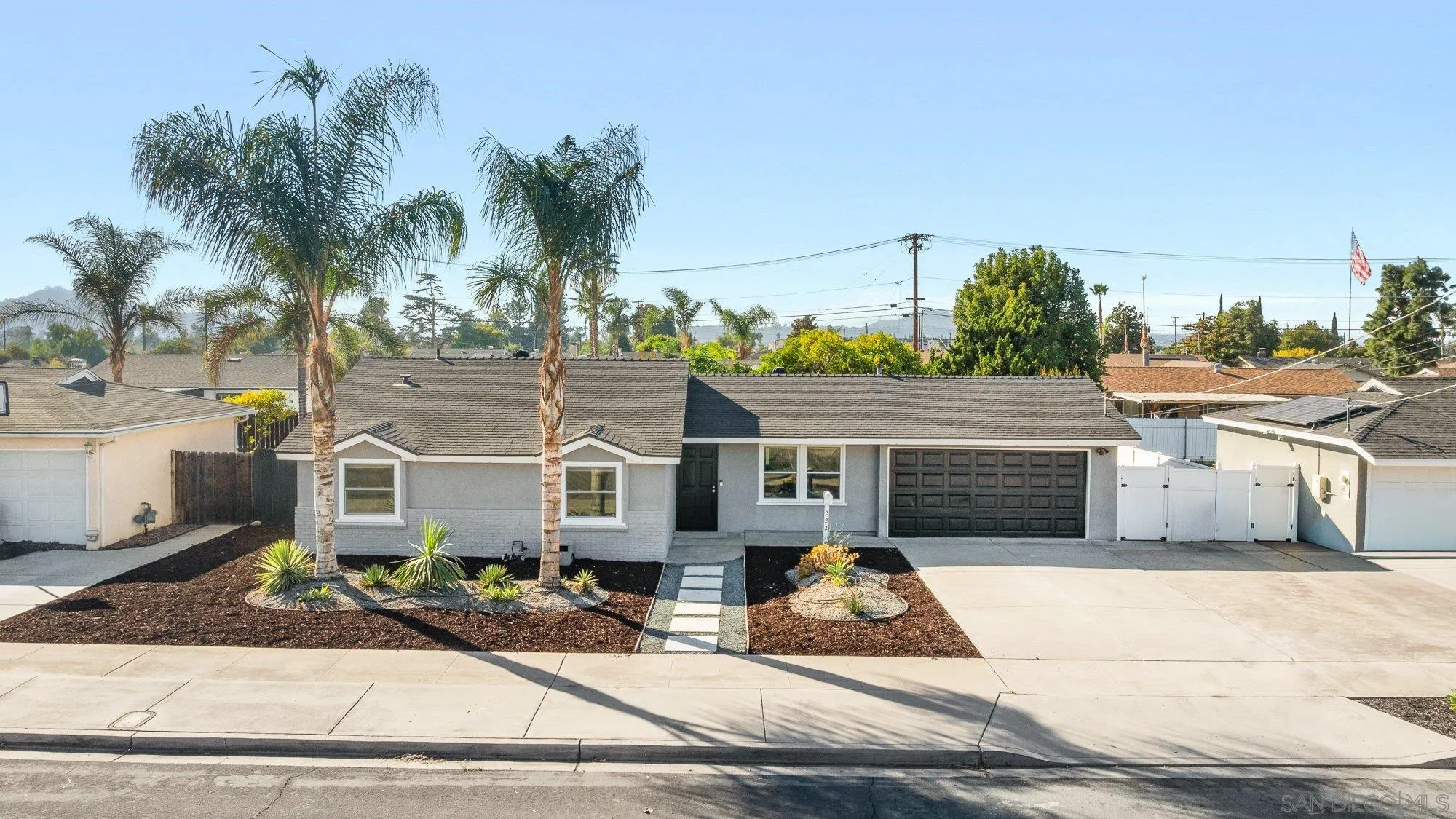 222 Gull Place El Cajon, CA 92019 - Photo 53 of 53 a view of a white house with a yard and potted plants