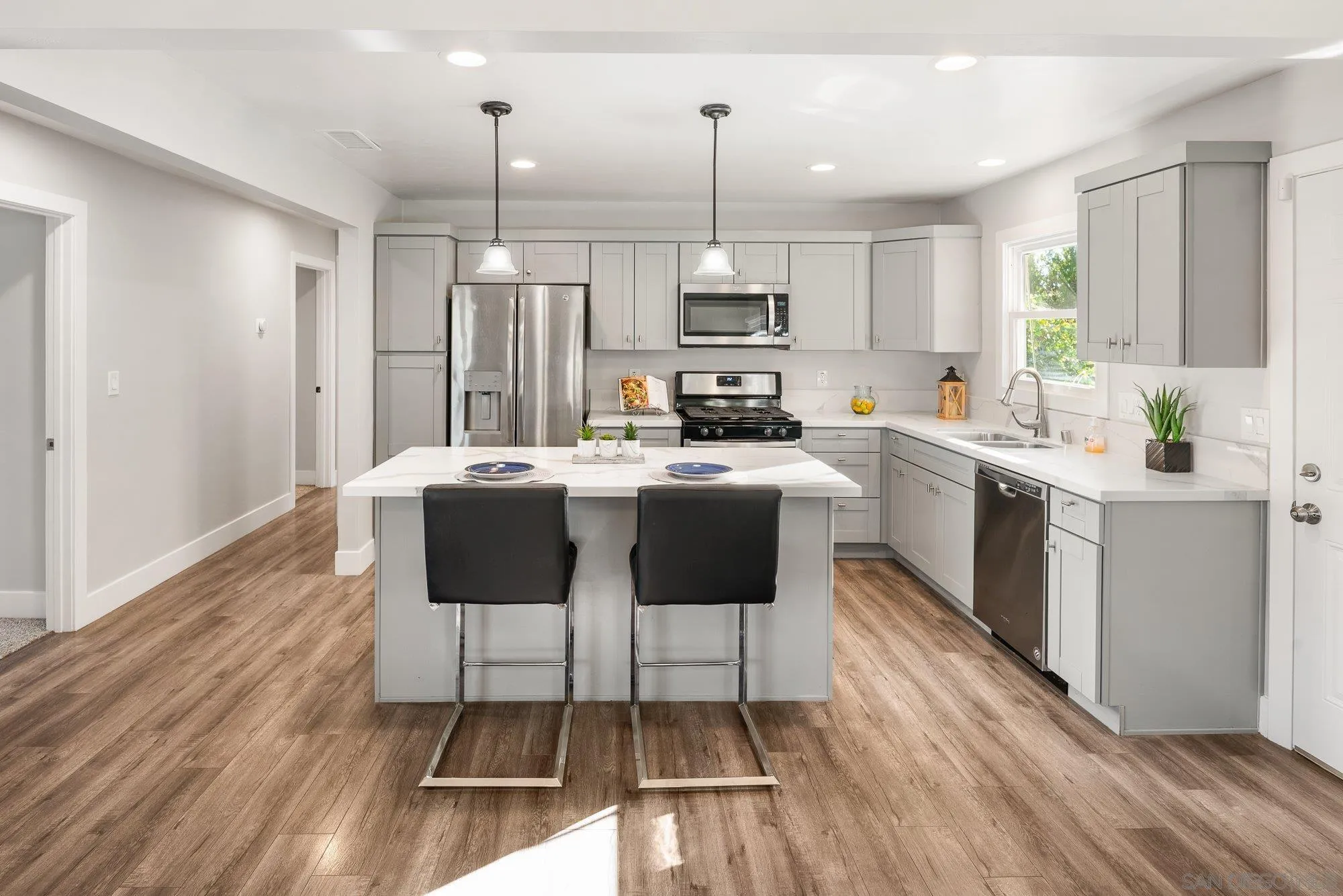 222 Gull Place El Cajon, CA 92019 - Photo 9 of 53 a kitchen with a sink a counter top space stainless steel appliances and cabinets
