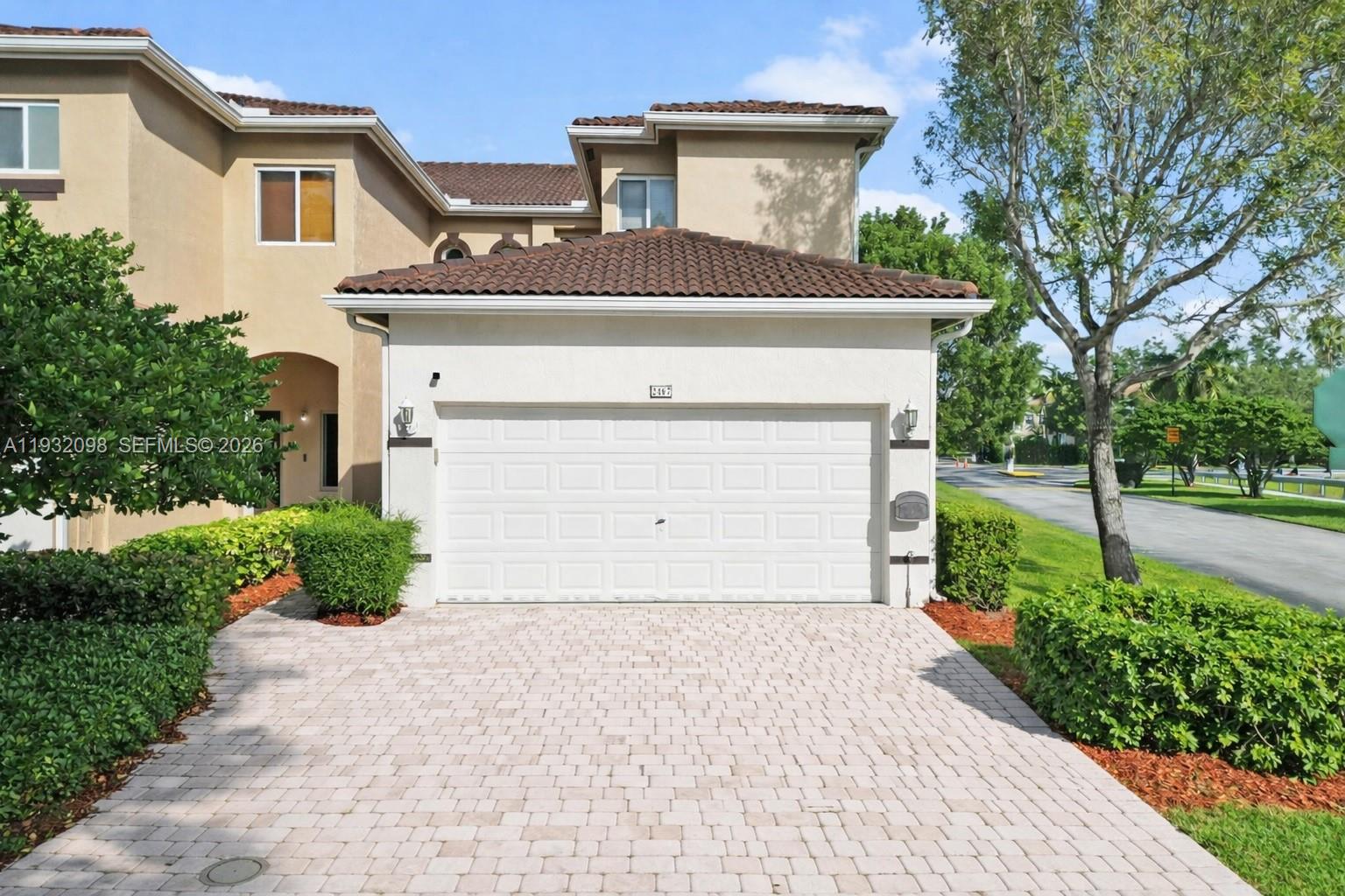 a front view of a house with a yard and garage