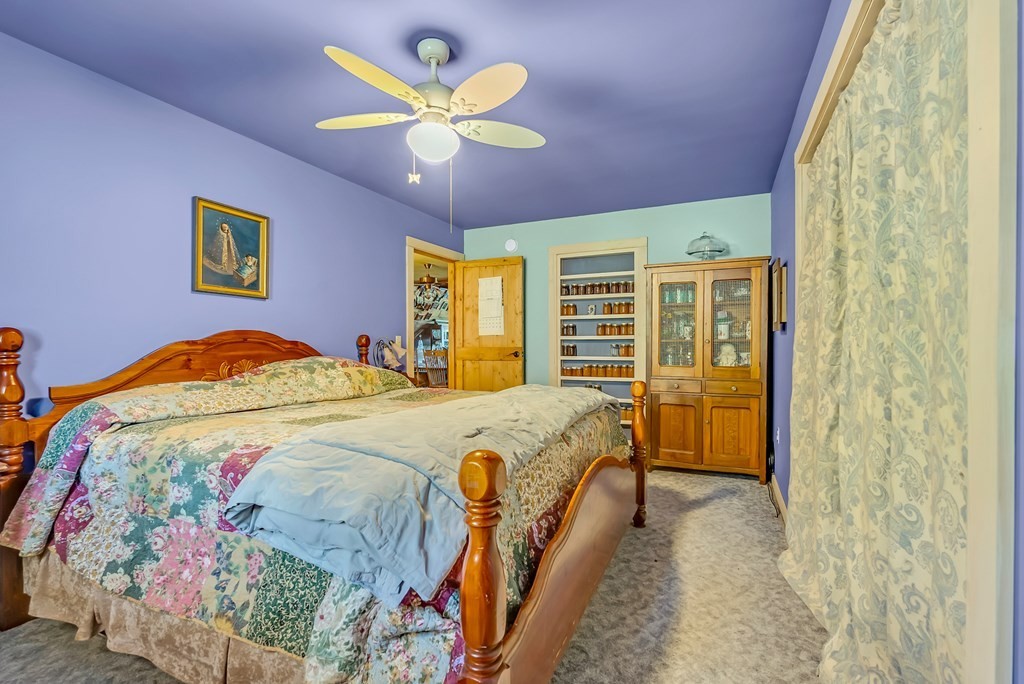 355 Dillon Gribble Road Sparta, TN 38583 - Photo 19 of 45 a bedroom with a bed and a chandelier