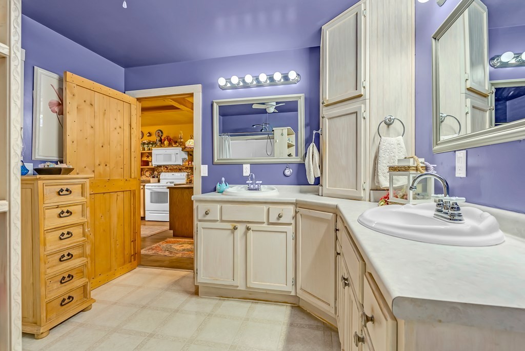 355 Dillon Gribble Road Sparta, TN 38583 - Photo 21 of 45 a spacious bathroom with a double vanity sink a mirror and a bathtub