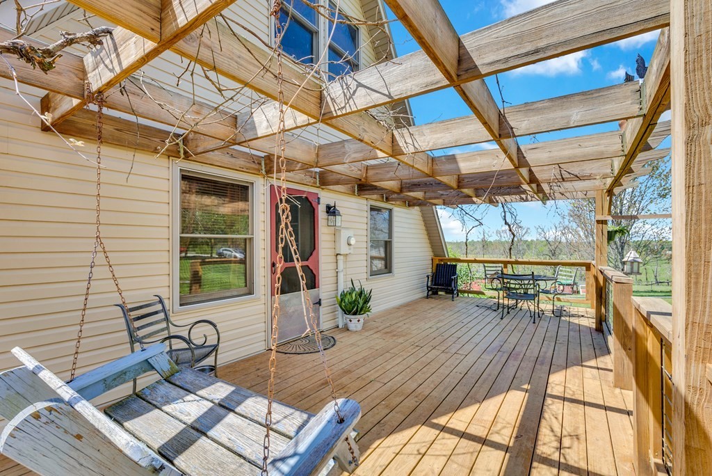 355 Dillon Gribble Road Sparta, TN 38583 - Photo 35 of 45 a view of a deck with couches chairs and wooden floor