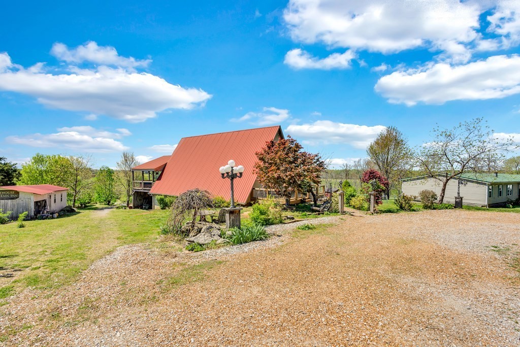 355 Dillon Gribble Road Sparta, TN 38583 - Photo 4 of 45 a view of a garden with a building in the background