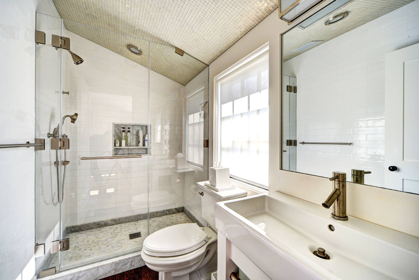 295 Main Street Sag Harbor, NY 11963 - Photo 12 of 21 a bathroom with a sink toilet tub and shower