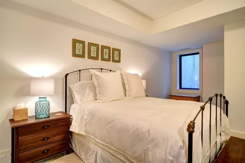 a bedroom with a bed and a night stand