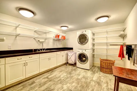 a utility room with sink dryer and washer