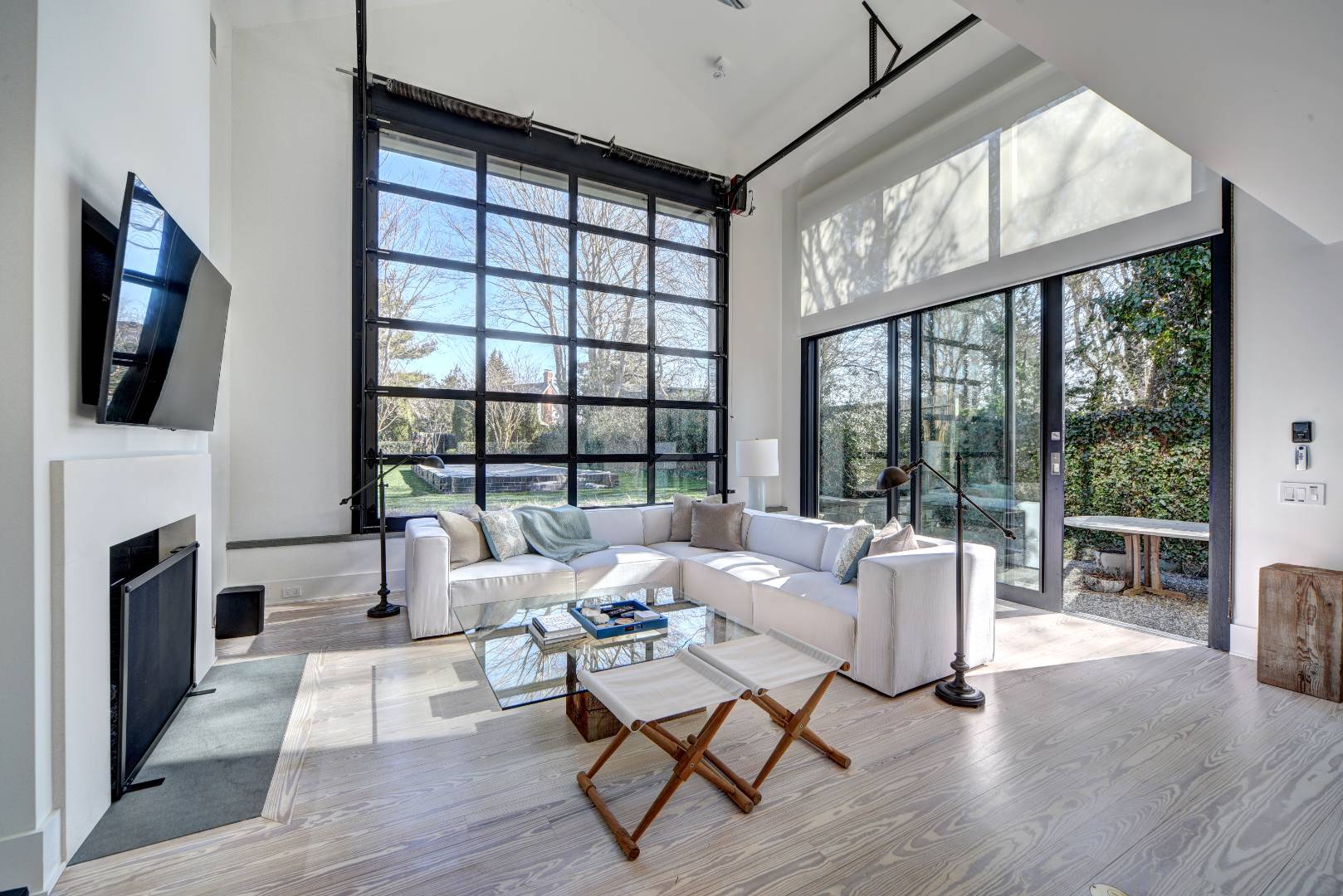 295 Main Street Sag Harbor, NY 11963 - Photo 3 of 21 a living room with furniture a fireplace and a flat screen tv