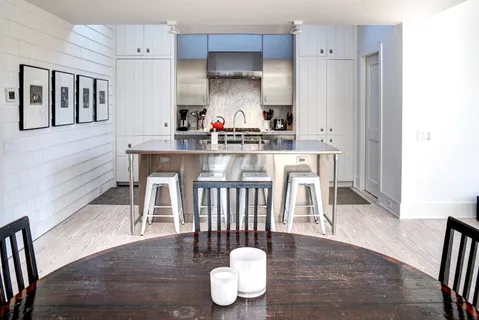 a kitchen with granite countertop white cabinets and stainless steel appliances