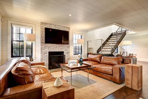 a living room with furniture fireplace and flat screen tv