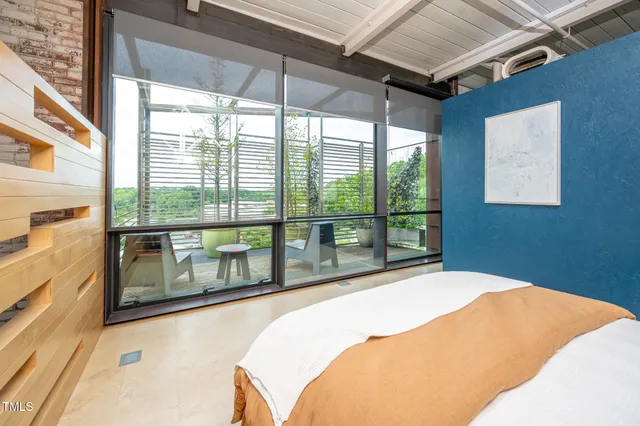 an aerial view of a house with roof deck and outdoor seating