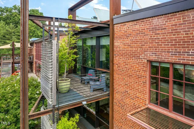 a view of empty room with stairs and wooden floor